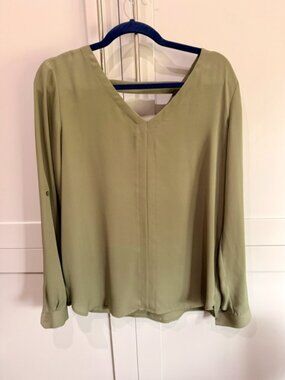 This sage green LOFT Outlet top features a classic crew neckline